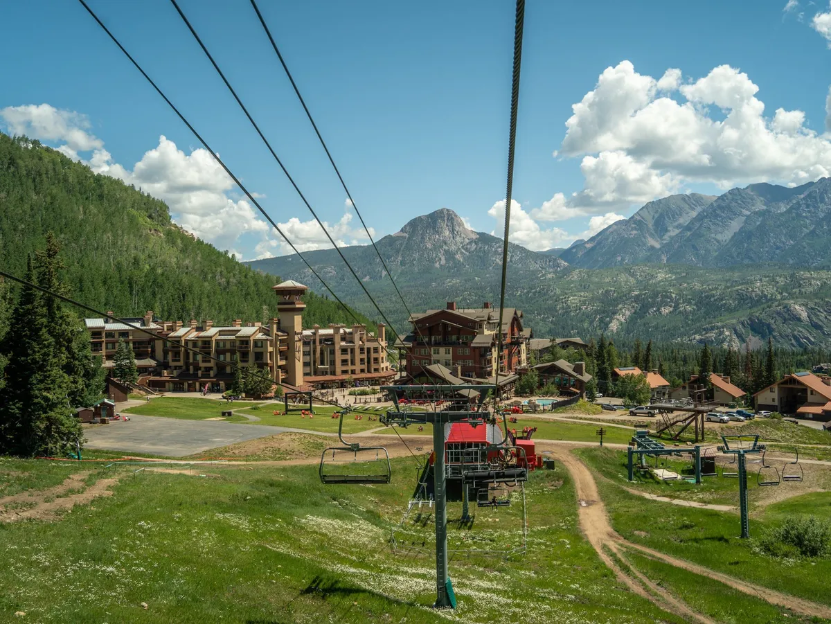 An exterior overview featuring the nearby Purgatory Resort, including a ski lift, resort building, and impressive mountain scenery. The image conveys the area's adventure opportunities and the proximity of family-friendly attractions.